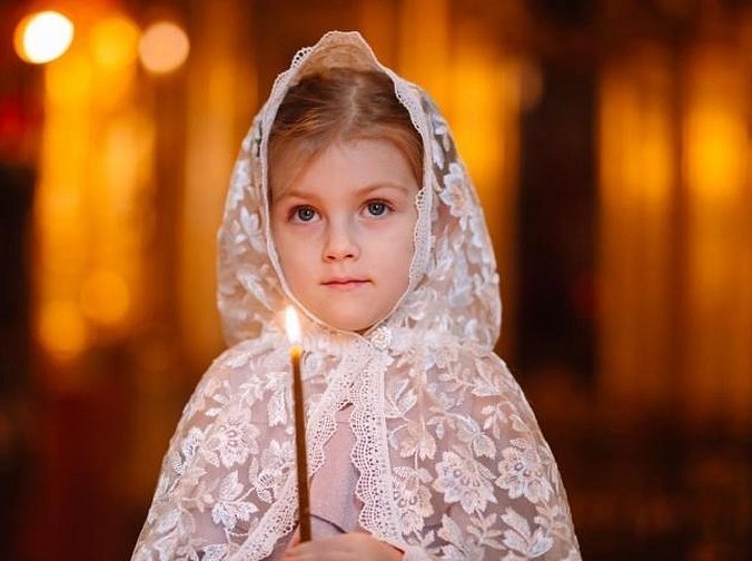 Девочка со свечой в церкви